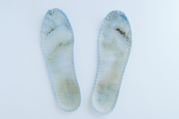 Dirty shoe insoles on white background close-up.