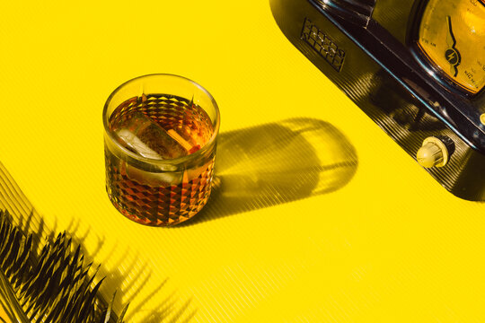 High angle view of cocktail liquor and old radio on table