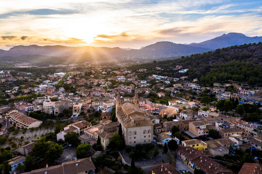 Spain, Mallorca, Calvia, Helicopter view of Parroquia Sant Joan Baptista church and surrounding buildings at sunset