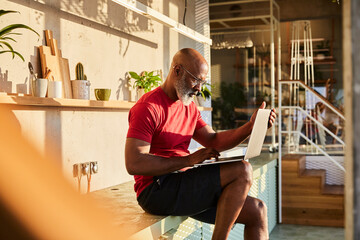 Businessman concentrating on work while using laptop at home