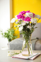 Beautiful bouquet of Chrysanthemum flowers on grey table indoors. Interior design