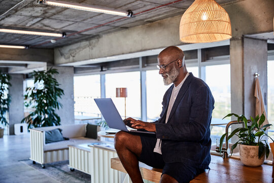 Man Working On Laptop While Sitting At Home