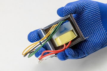 technician worker holding at his hand radio electric transformer isolated on white background....