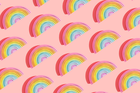 Multiple image of colorful wooden rainbow toys on colored background