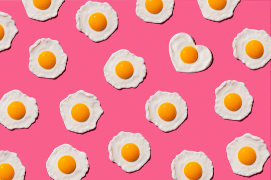 Pattern of fried eggs with single heart shaped one