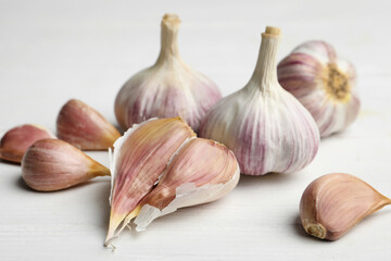 Fresh organic garlic on white wooden table, closeup