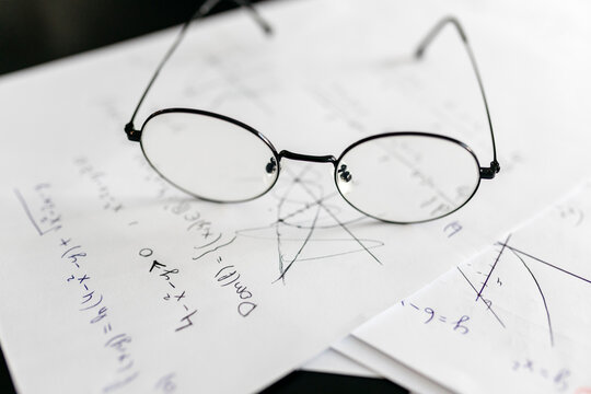 Close-up of eyeglasses on mathematics equations at home