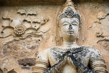 A Buddha statue on the wall at Wat Sam Yot, Chiang Mai