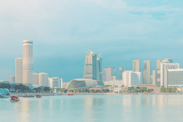 Marina Bay and Esplanade Theater in front of river against blue sky