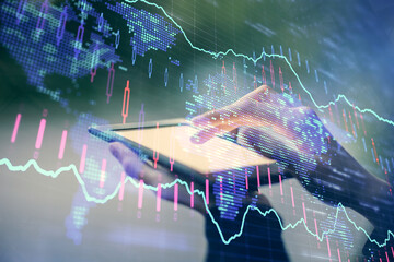 Double exposure of forex chart sketch hologram and woman holding and using a mobile device. Financial market concept.