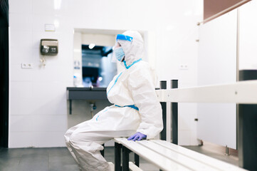 Healthcare man sitting on bench in medical room at hospital