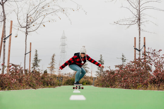 Young woman skateboarding outdoors
