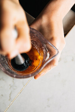 Bartender muddling Orange Peel