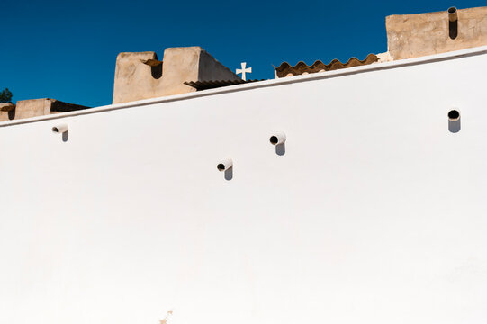 Abstract pattern of of vent tubes on a white wall