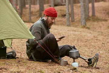Young Traveller Using Gadget In Forest