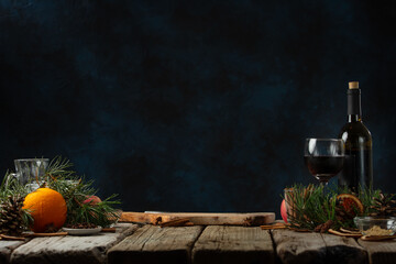 Worksplace for preparing mulled wine. Rustic wooden table with festive composition background. Backstage of cooking hot drink with fragrant spices.