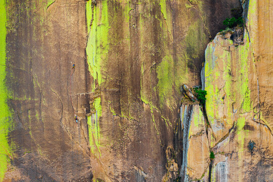 Aerial shot of first on the rope climber on scenic crack on bigwall