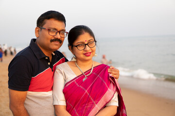 Middle aged Indian couple in a vacation at sea shore