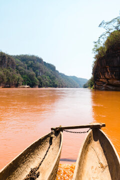Wooden pirogue on the river at sunlight