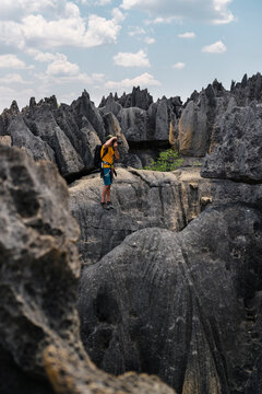 Adventurer taking picture near rock formation