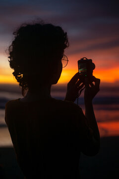 A girl make a photo by digital photo camera