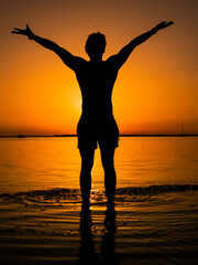 Fototapeta premium Shadow of the person on sunset. Make your dreams come true. Success story. Victory, independence, strength.