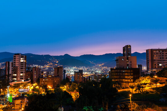Residential neighborhood skyline with foggy hills on background at dusk in Medellin