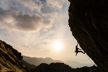 Active climbers enjoying extreme sport in rocky landscape on sunny day