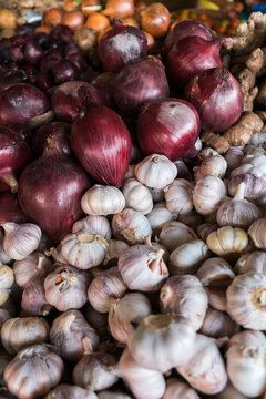 Bunch of red onions and garlic in the counter of a street market