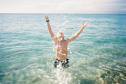 boy at beach on sunny day and pool having fun