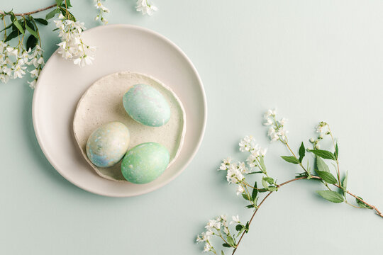Colorful dyed eggs on plates