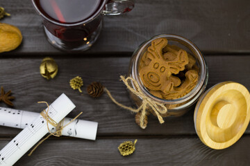 top view, mugs of Mulled wine with orange, jar of cookies, musical notes decor