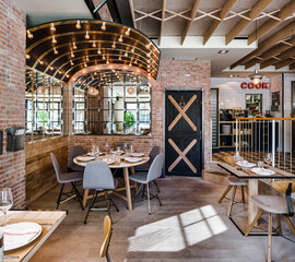 Front view of modern restaurant in wooden tonnes and light bulbsin loft style