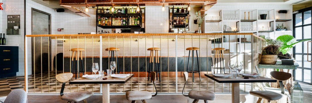Panoramic view of empty restaurant with counter and dining zone