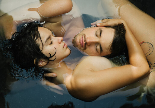 Beautiful, young couple cuddling in the bathroom