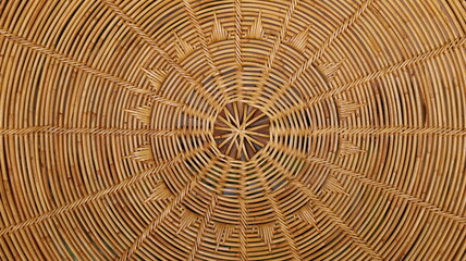Rattan weave circular pattern. Hand-woven local crafts are beautifully woven rattan furniture. Full frame brown textured background. Close focus and select an object