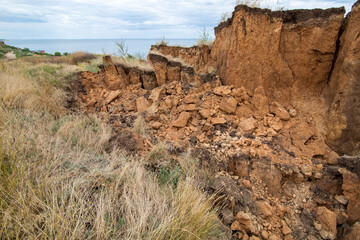 Soil landslide on slopes after degradation of the soil rain or underground water and an earthquake,...