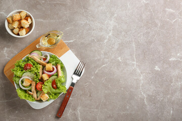 Delicious fresh chicken salad served on grey table, flat lay. Space for text