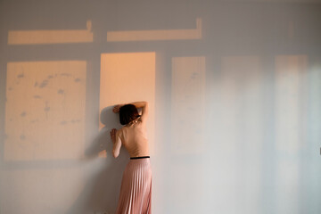 woman leaning against a wall