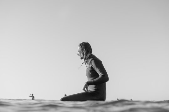 surfer guy sitting on board in the ocean