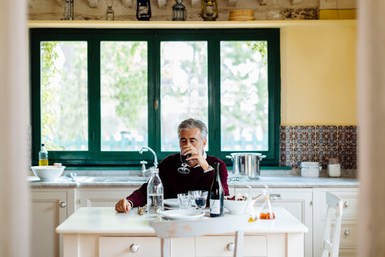 Mature male drinking wine during lunch
