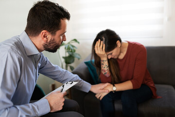 Male psychologist helping a depressed woman