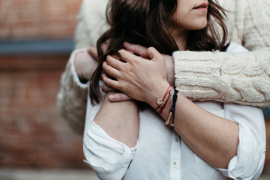 Young loving couple hagging on the walk in city.
