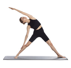 Young woman in sportswear practicing yoga on white background