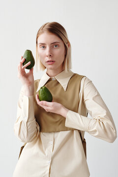 Stylish Woman With Two Avocados