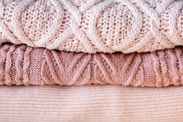 A stack of knitted sweaters.