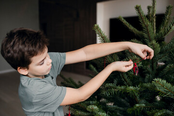 Young boy decorate the room for Christmas