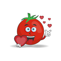 Tomato mascot character holding a love icon. vector illustration