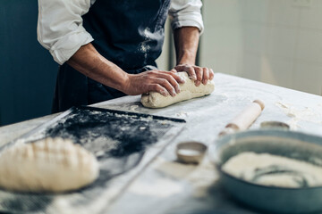 Crop chef making bread on table