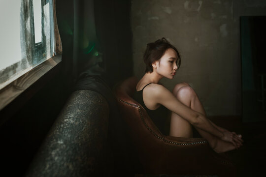 Asian girl in a dark room.